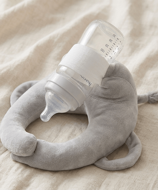 Sipee Sip grey feeding pillow holding a bottle