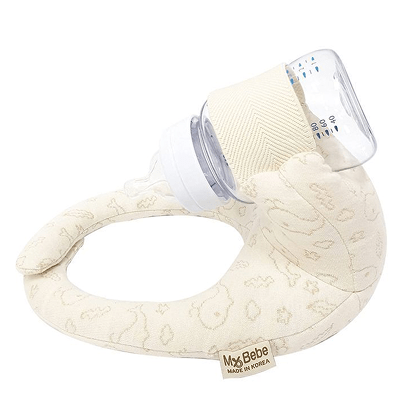 Sipee Sip hands-free baby bottle feeding pillow in cream holding a bottle